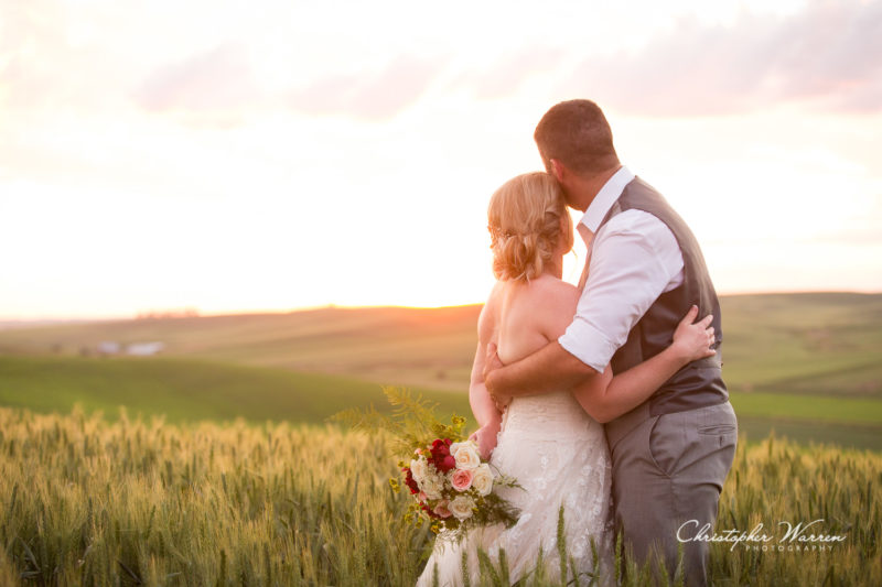 bride and groom looking into sunset